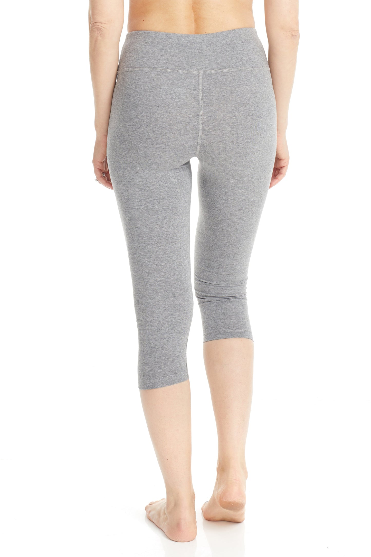 plus size woman wearing half leg grey capri leggings