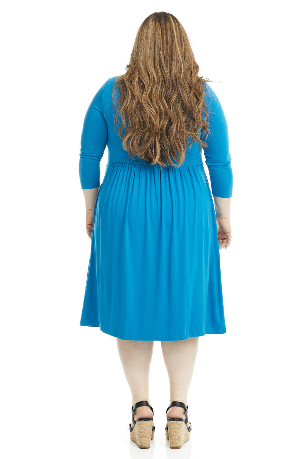 plus size woman wearing a modest blue 3/4 sleeve knee length dress