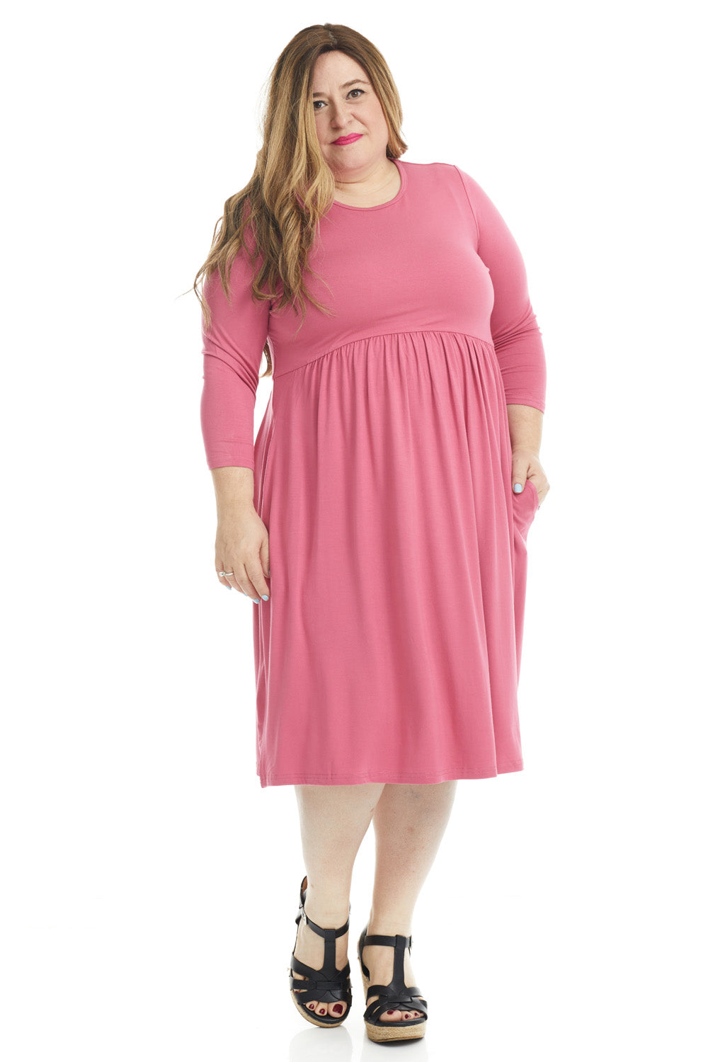 plus size woman wearing a modest pink 3/4 sleeve knee length dress