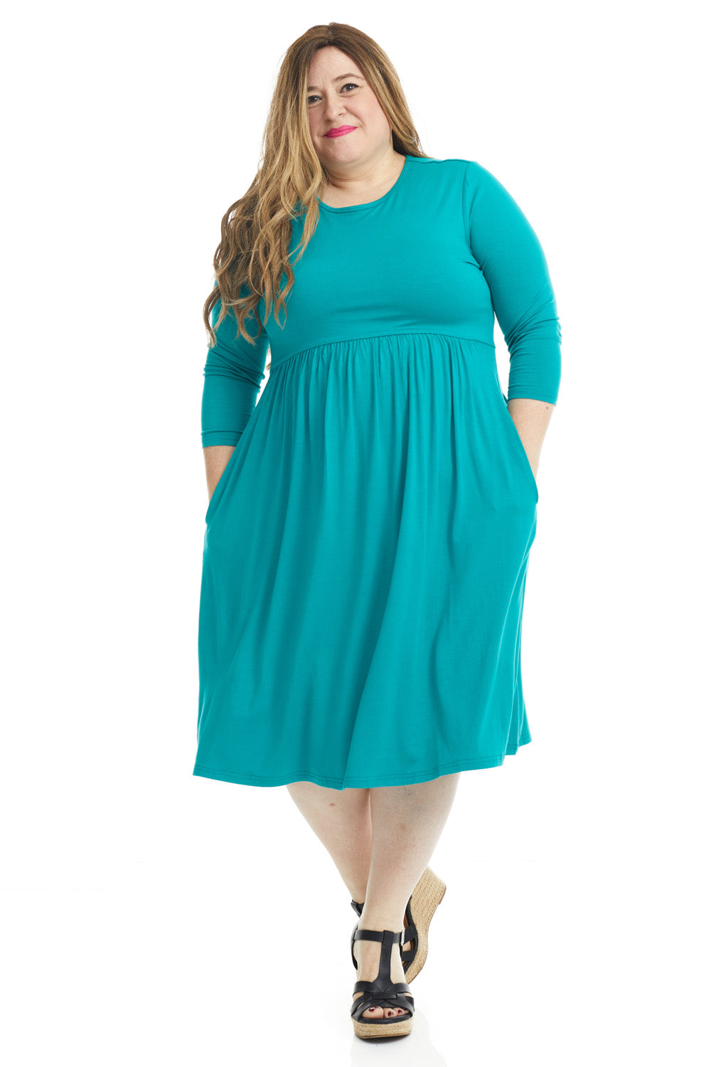 plus size woman wearing a modest teal 3/4 sleeve knee length dress