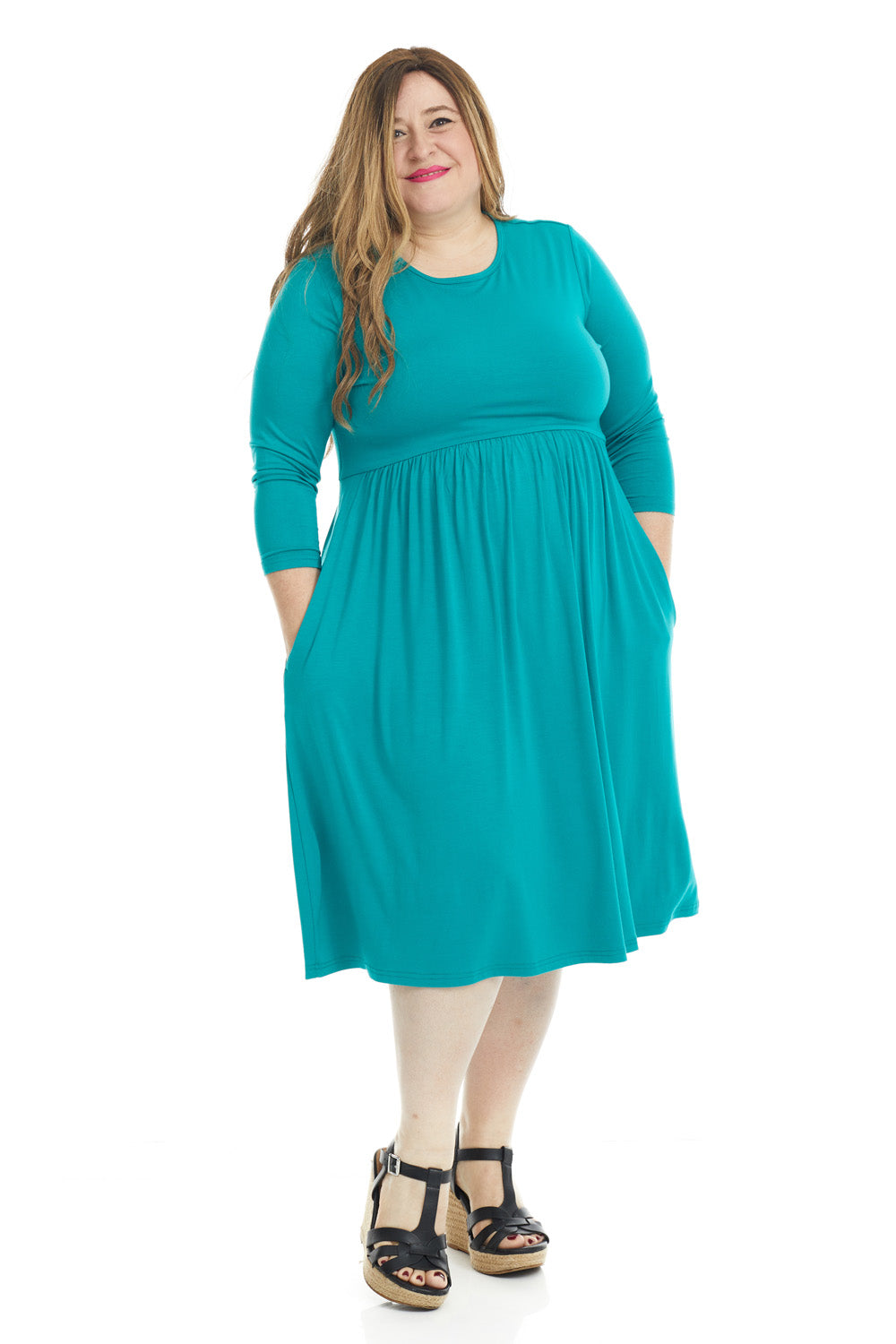 plus size woman wearing a modest teal 3/4 sleeve knee length dress