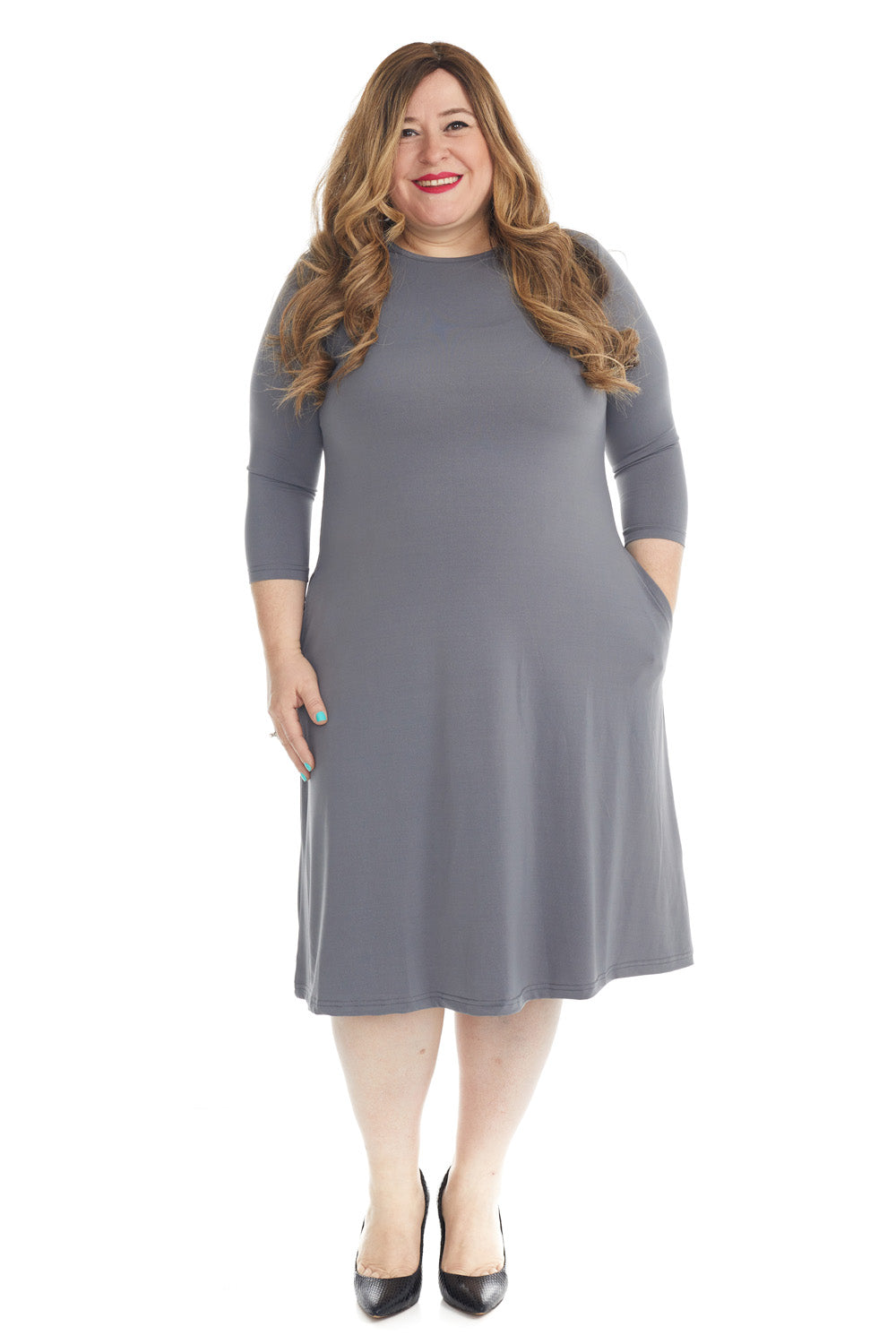 plus size woman wearing charcoal grey flary 3/4 sleeve knee length modest dress