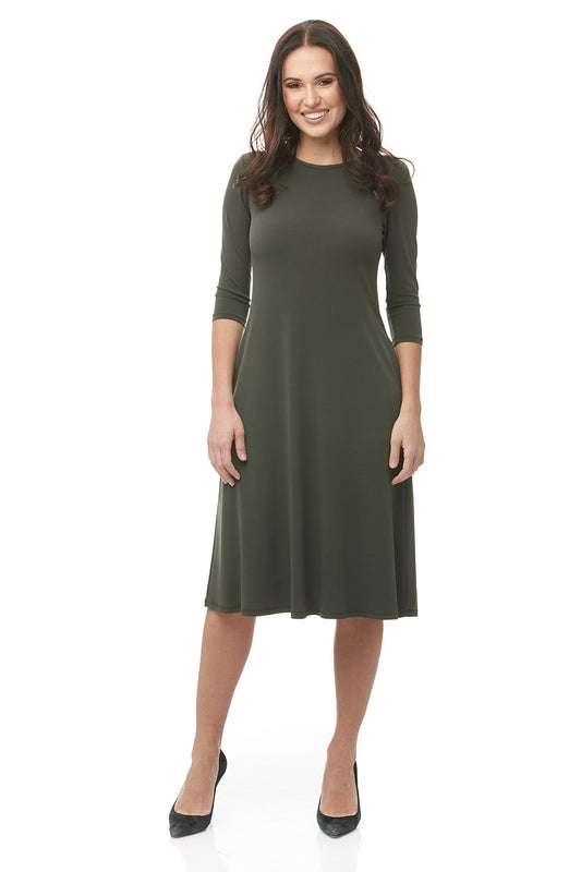 woman wearing green flary 3/4 sleeve knee length modest dress